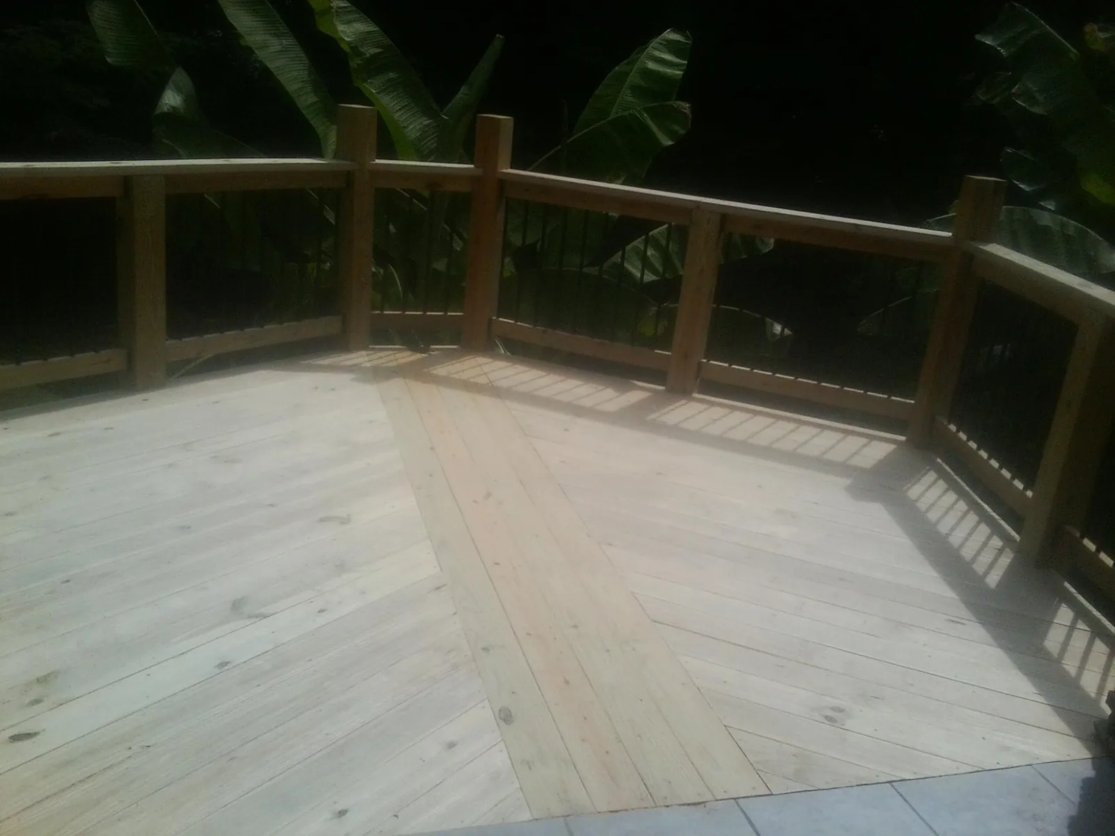 New wood deck and railing built off the back of a home in Haydenville